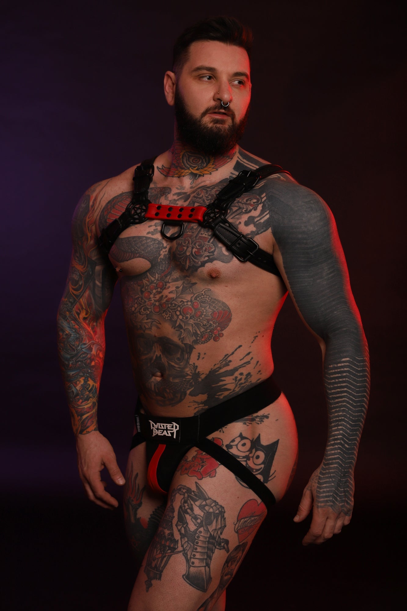 A product photo on a model of a Beast Harness in red.