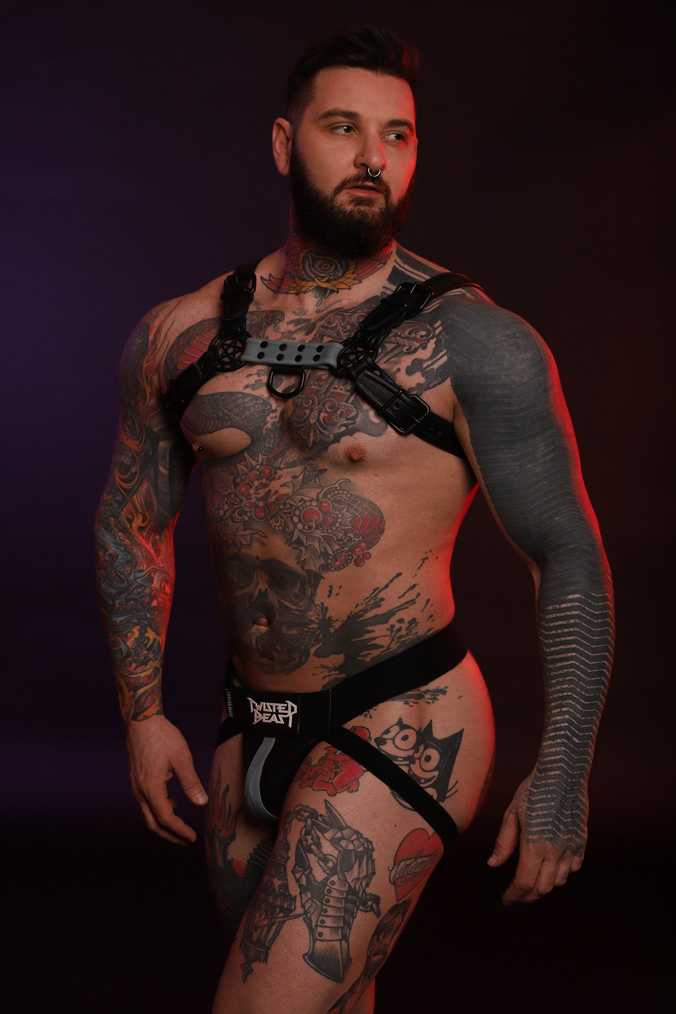A product photo of a model wearing a grey leather Beast Harness.