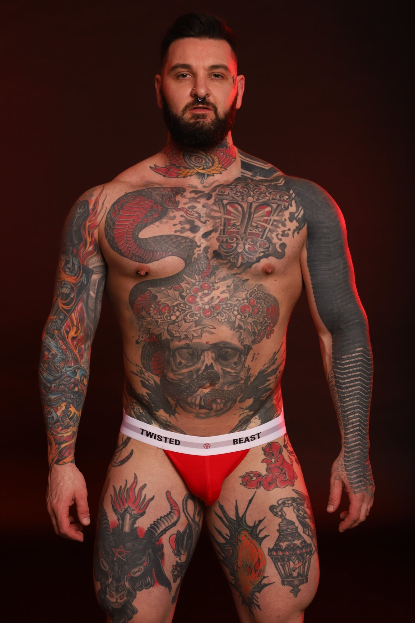 The front of a Twisted Beast Model wearing a red Insignia Jock.