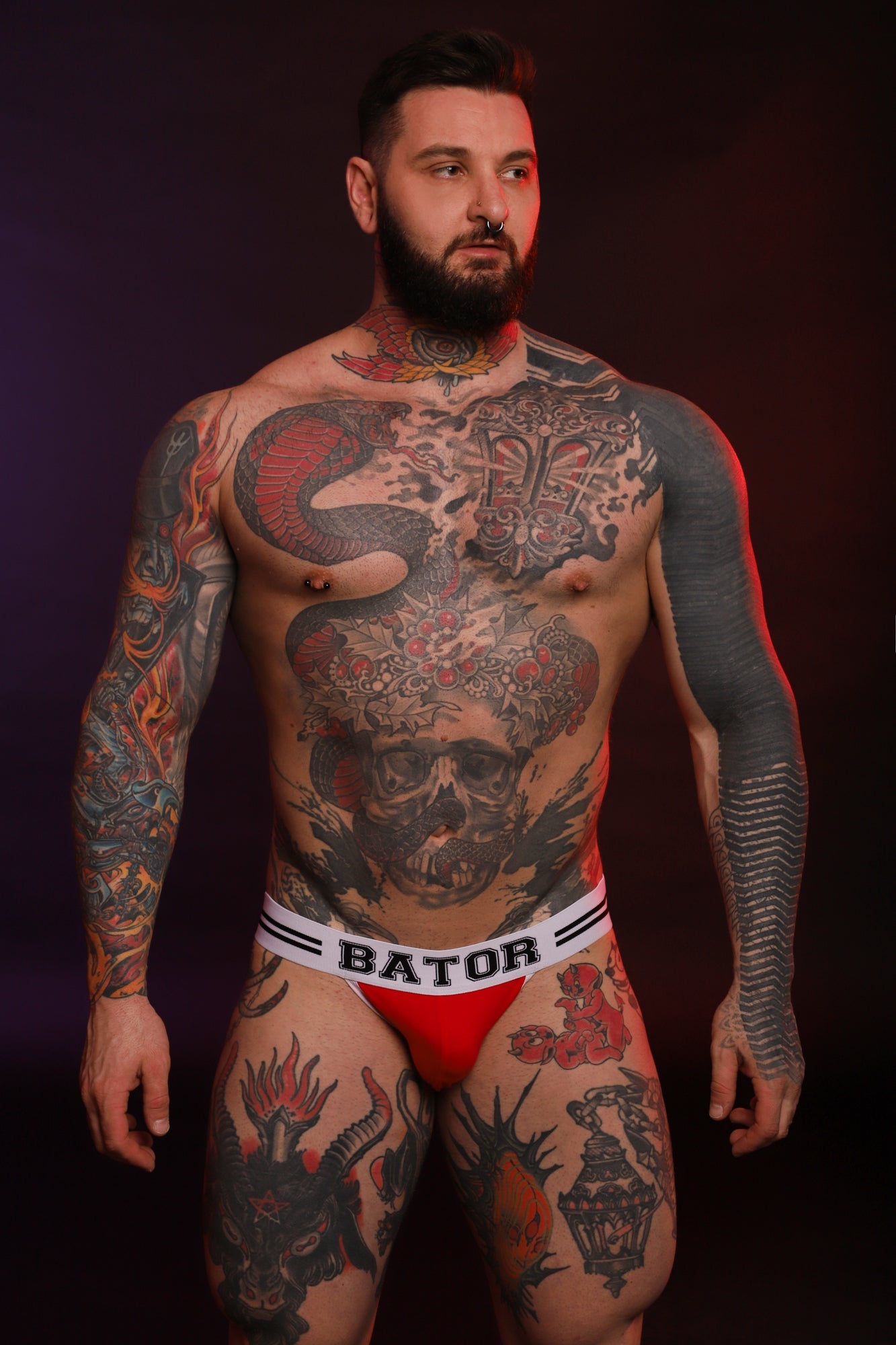 A man wearing a red Bator Jock by Twisted Beast while facing the camera.