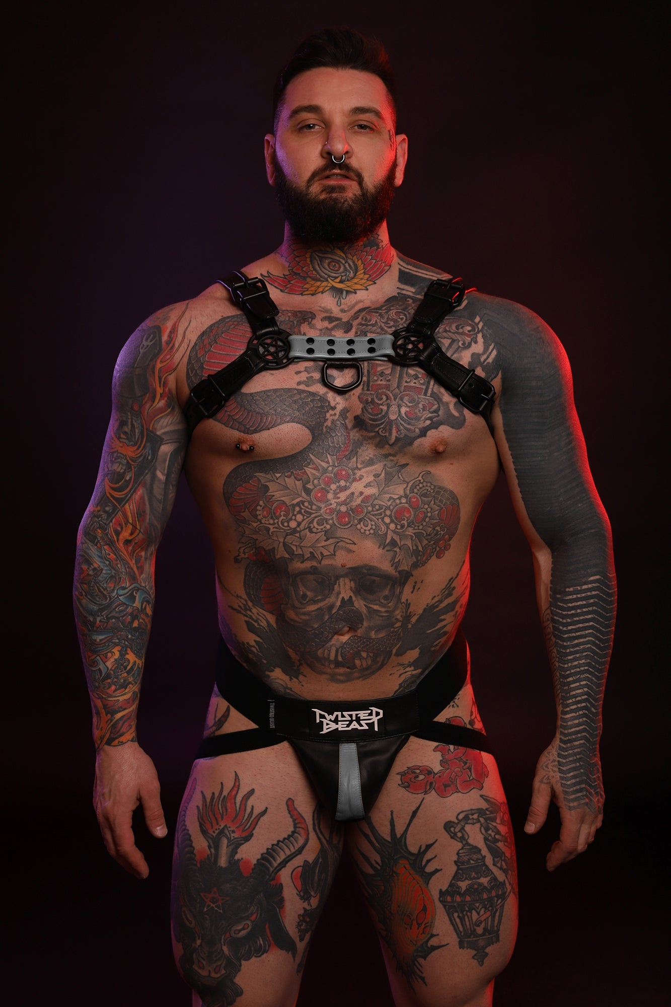A product photo of a model wearing a grey Beast Harness and Beast Jock. 