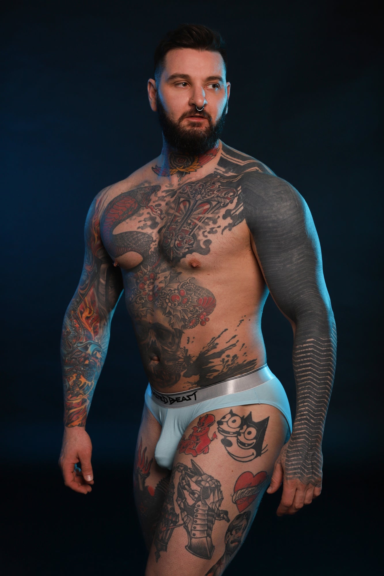 A model wearing a blue pair of Y2K Brief's by Twisted Beast.