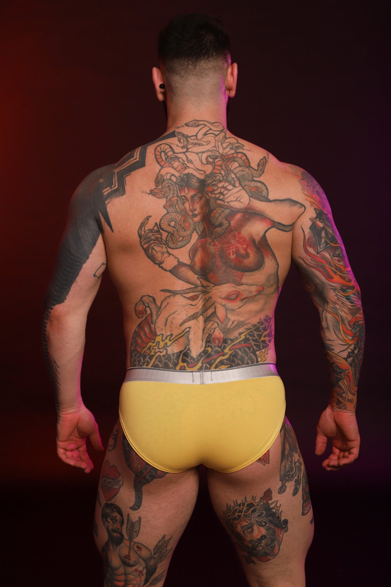 A model wearing a pair of yellow Y2K Briefs from the back.